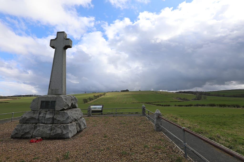 Flodden Field memorial, located at about the centre of the English line. Looking across the low boggy area towards the Scottish positions on the high ground beyond.