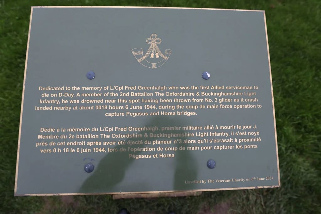 Pegasus Bridge plaque to Lance-Corporal Fred Greenhalgh, who was knocked unconscious and thrown from Glider No. 3 during landing. . Tragically, LCPL Greenlalgh drowned in the pond next to the canal