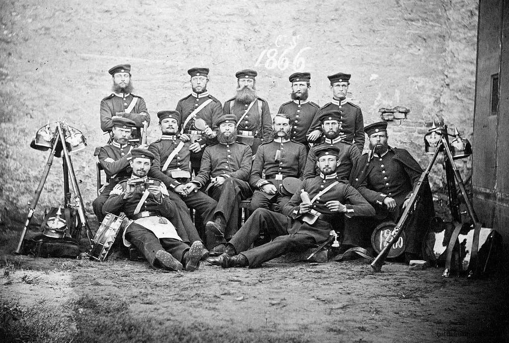 Prussian soldiers of the Garde Fusilier Regiment. Identifiable by their Model 1860 pickelhaubes with Garde stars, and their stacked Dreyse Model 1860 Zündnadel Füsiliergewehrs