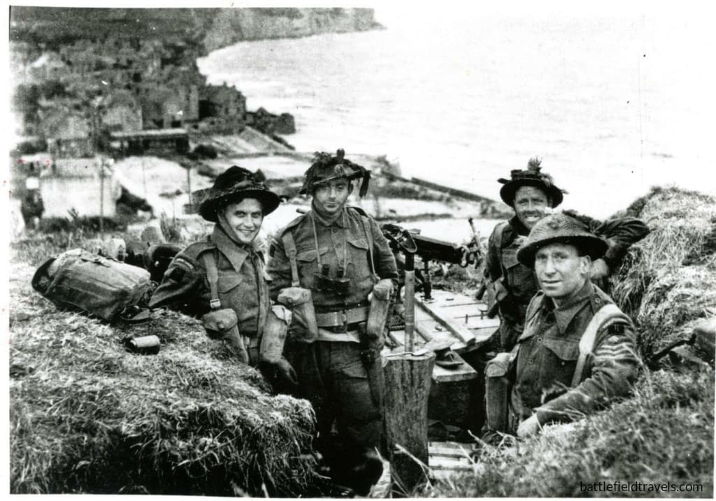 British soldiers of 1st Battalion, the Hampshire Regiment securing the high ground east of Arromanches. Arromanches visible in the background.