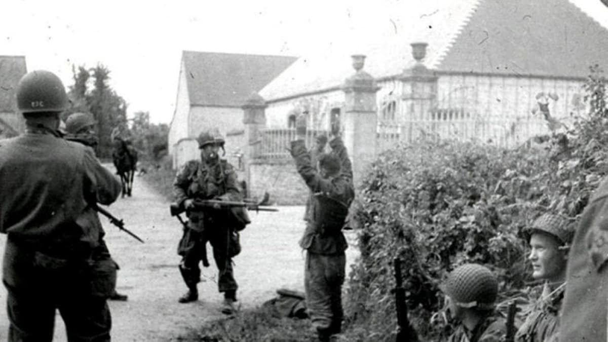 A 'behind the scenes' photo of PFC Shanklin accepting the German soldier's surrender in Turqueville. Clearly a well-staged shot!