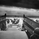 Robert F. Sargent's famous photo of Easy Company, 16th Infantry Regiment landing at FOX GREEN Sector, Omaha Beach on D-Day. Aerial shot from the same location in November 2024.
