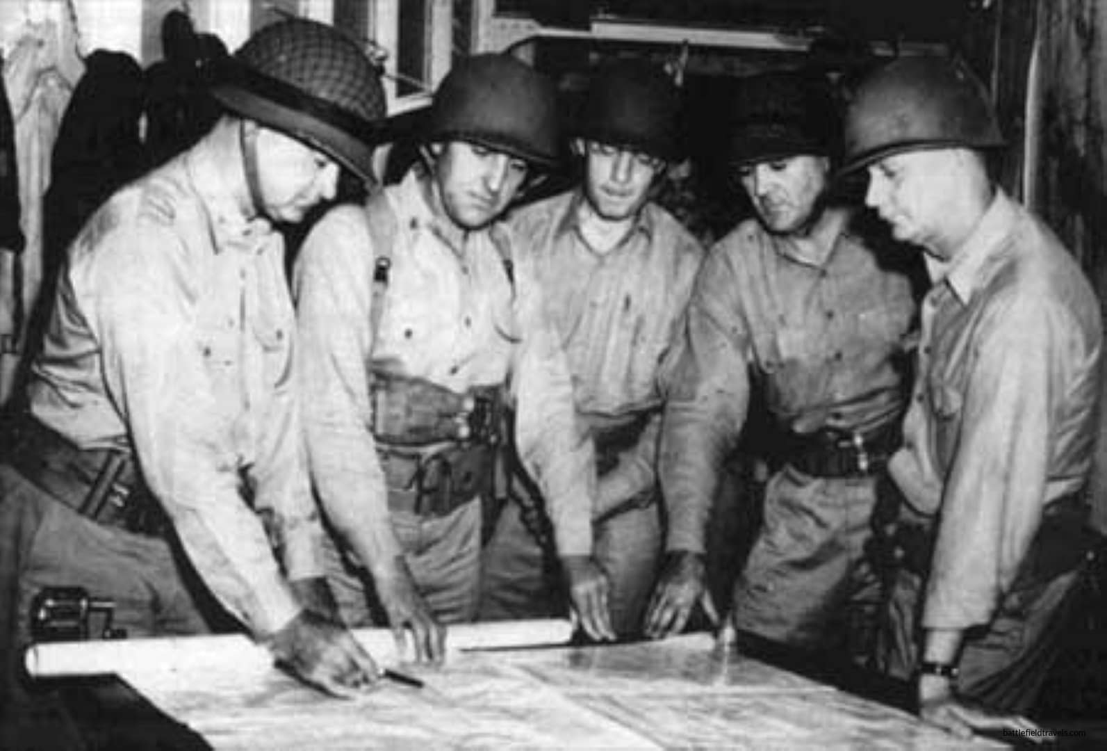MajGen Alexander A. Vandegrift, CG, 1st Marine Division, confers with his headquarters staff. From left: Gen Vandegrift; LtCol Gerald C. Thomas, operations officer; LtCol Randolph McC. Pate, logistics officer; LtCol Frank G. Goettge, intelligence officer; and Col William Capers James, chief of staff.