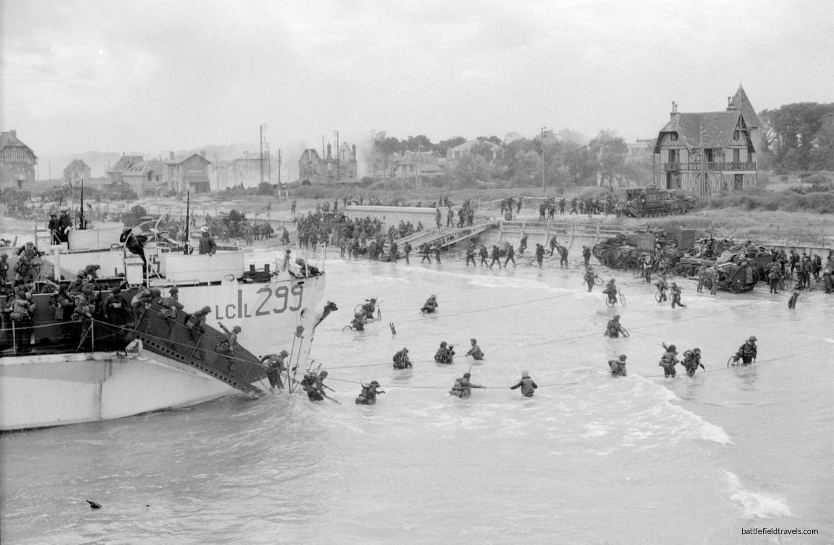 Juno Beach. Canadian 9th Brigade second wave landing at Bernieres-sur-Mer. Canada House visible in the background.